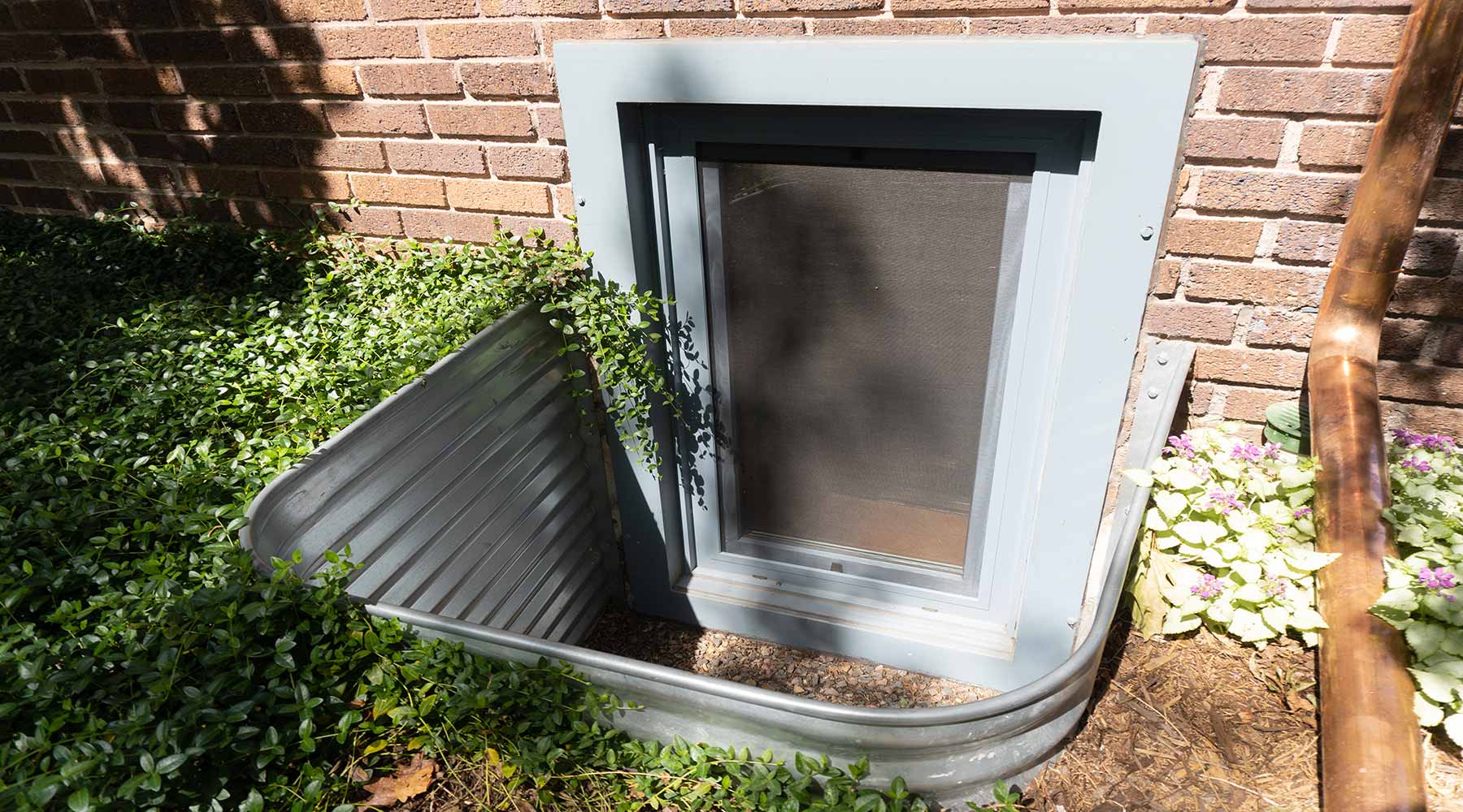 egress window well with ExoFrame and landscaping