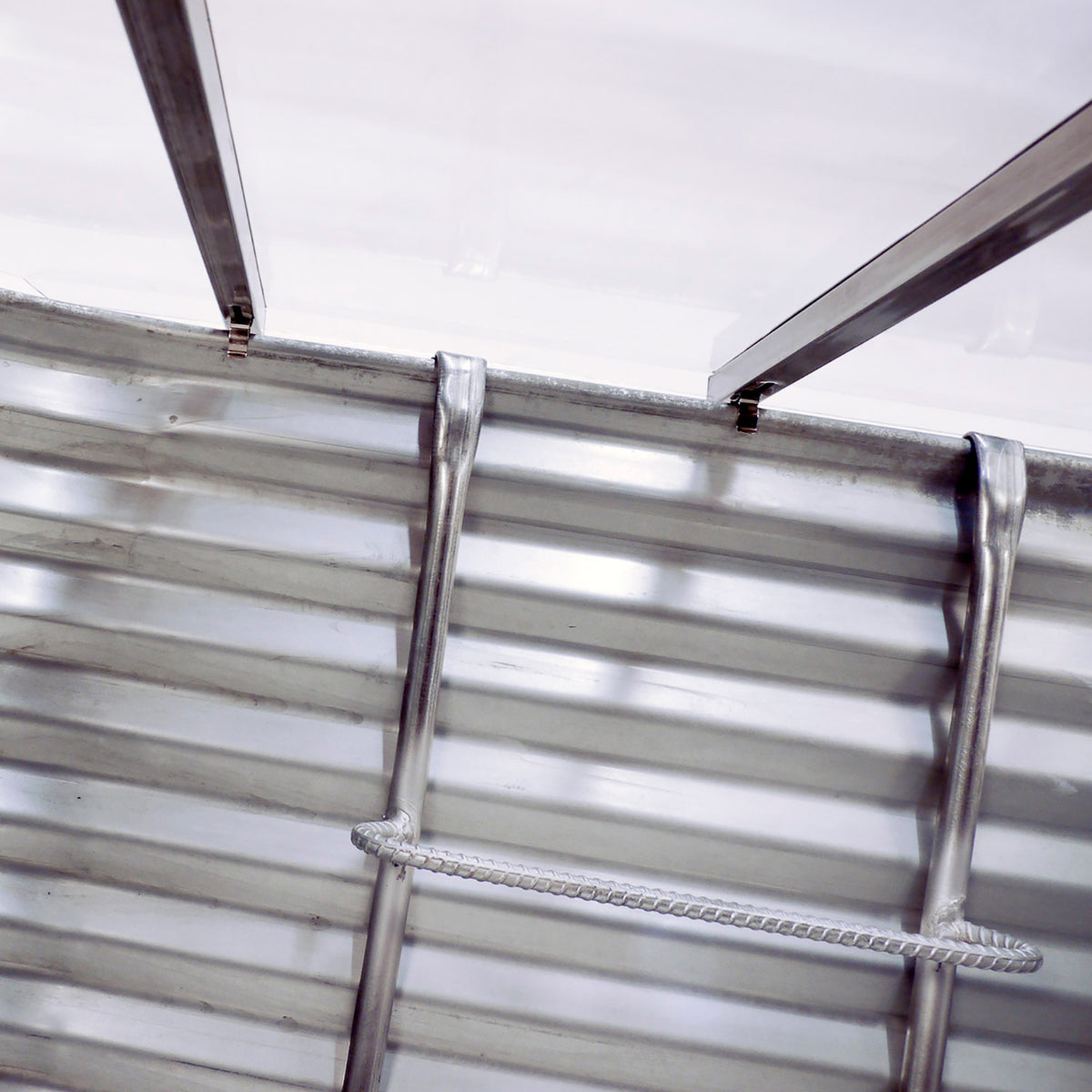 Detail of Bright Idea Egress clear well cover with clips designed to precisely fit our egress window wells