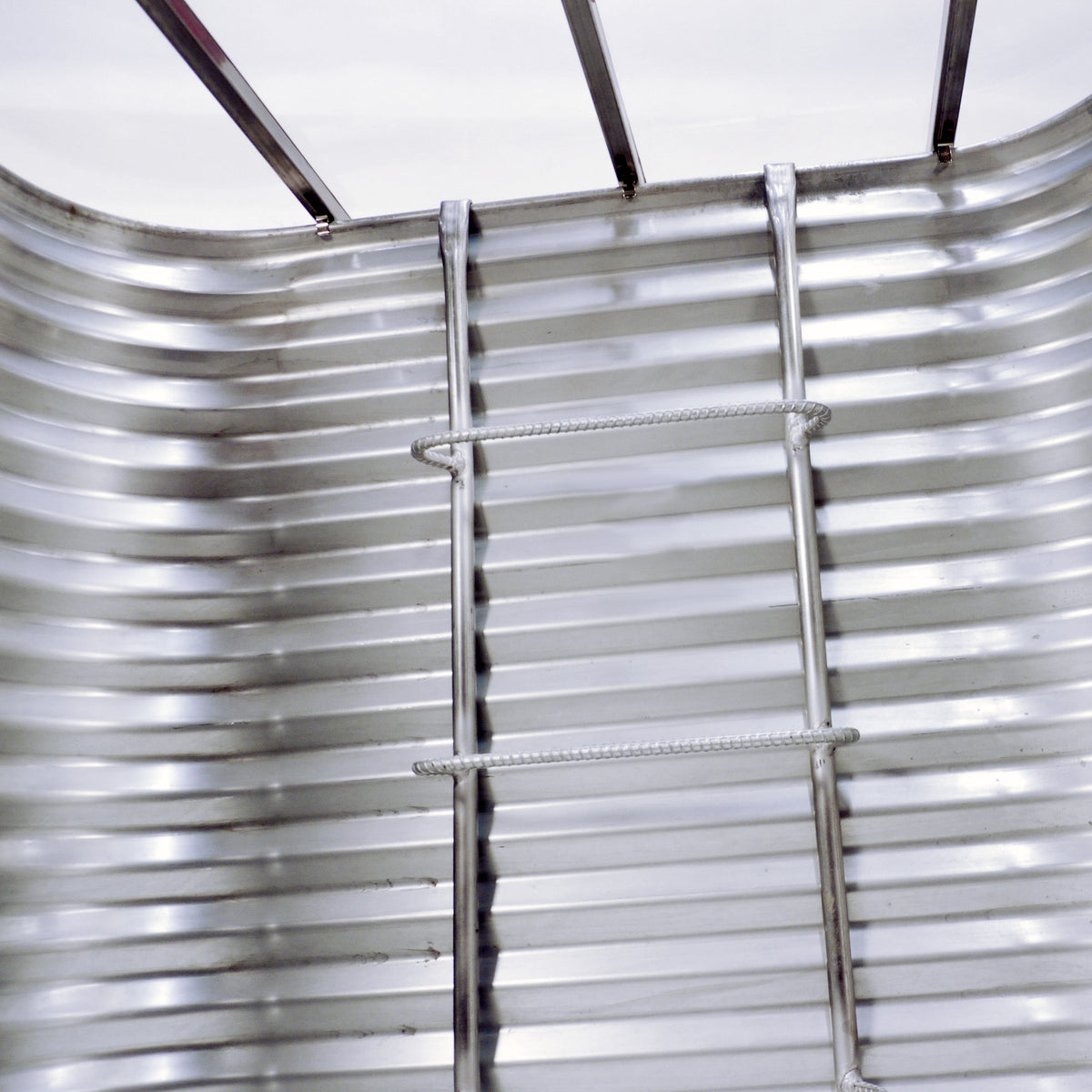 Detail of Bright Idea egress window well showing clear well cover and ladder